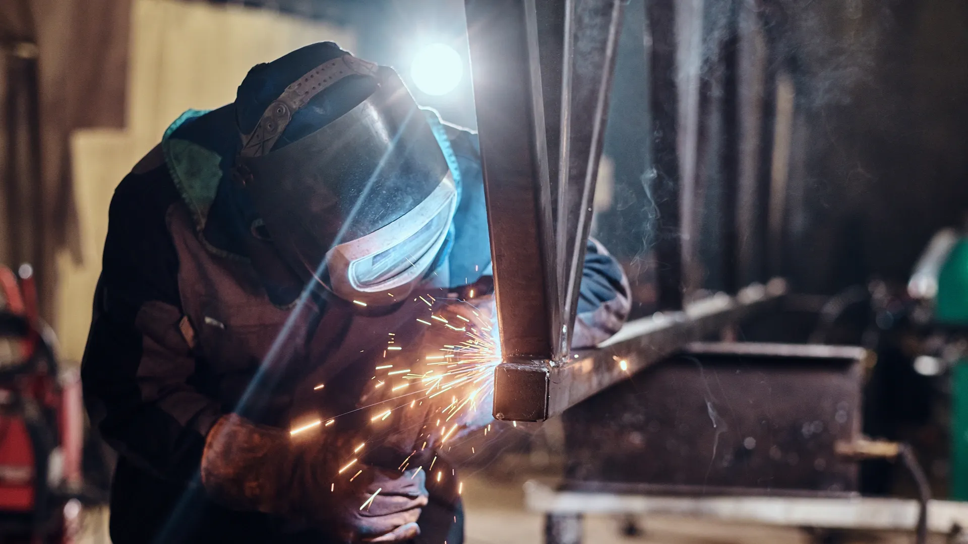 man-is-working-at-metal-factory-he-is-welding-a-piece-of-rail-using-special-tools (2) (1)